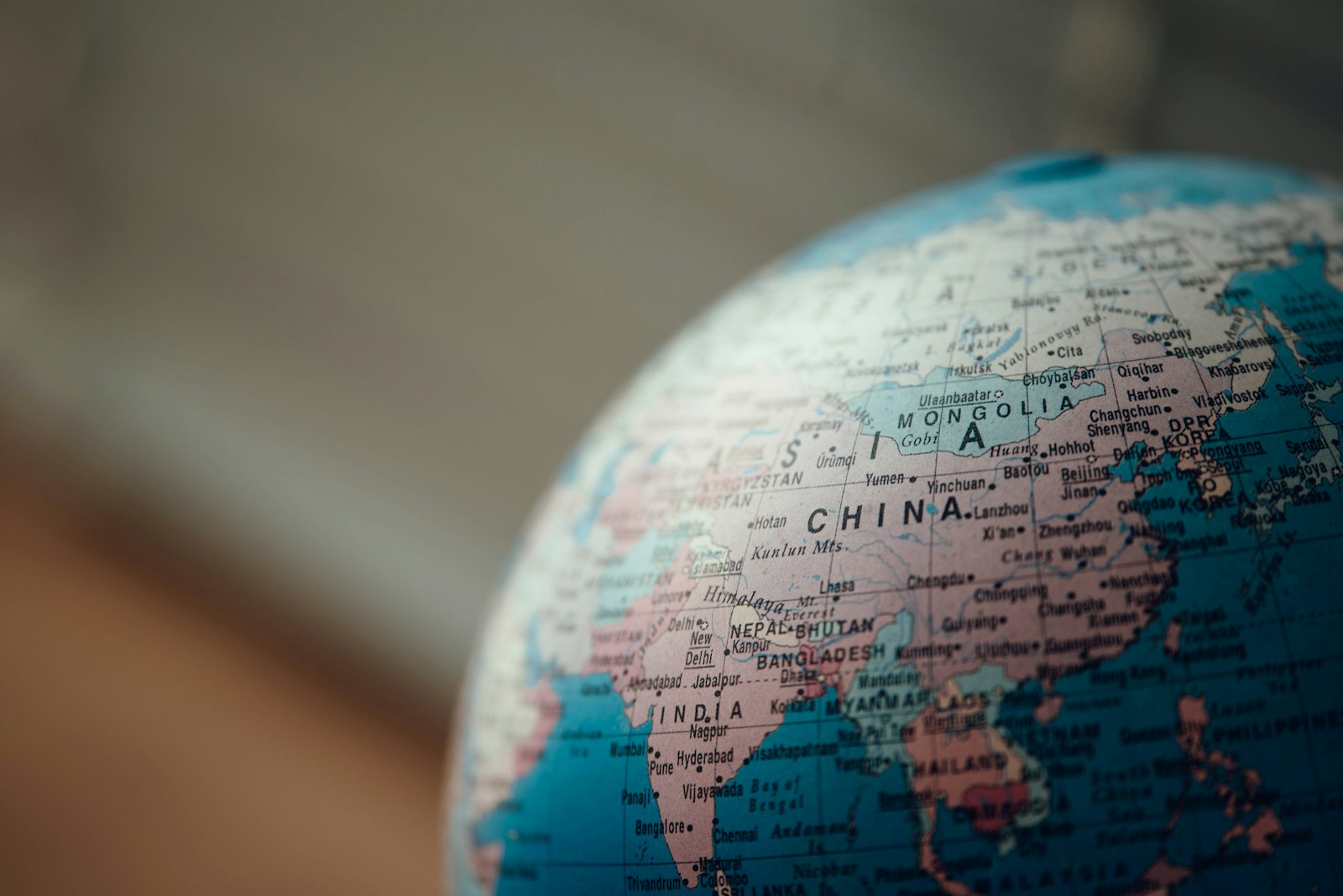 Close-up of a desk globe showing India, Singapore and surrounding Asia — markets indie devs leave behind when they ship en-US only